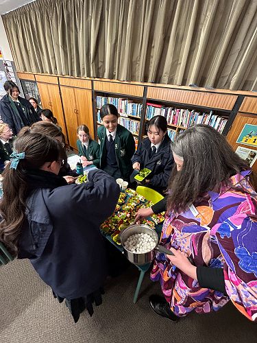 Mrs Pettigrew, Raina, Ping and Celina (Year 11) serve the sundaes.