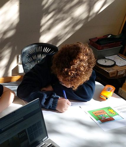 Jonah writing a retell of the Duck Song