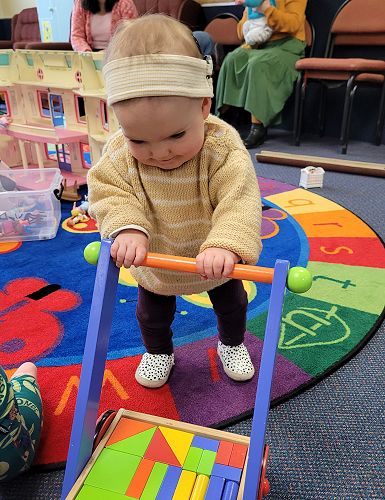 Isla practicing her walking at Dunedin Playgroup