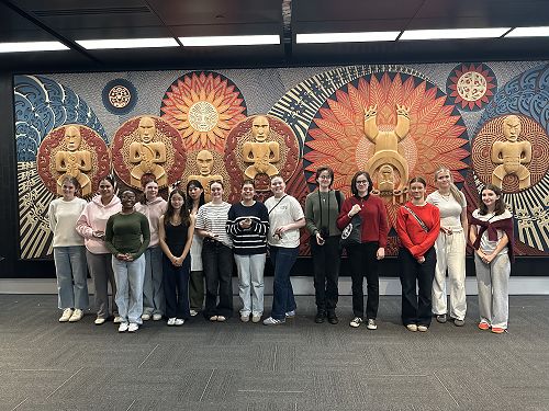 By the Māori creation story carvings at the National Library