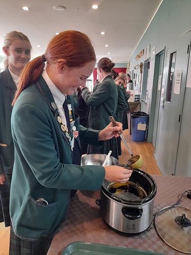 Pip collects a sample of kawakawa balm.