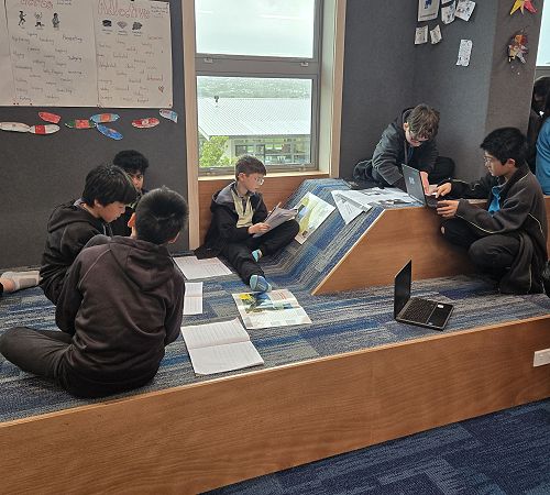 Learning on the blue bleachers in Pōhutukawa