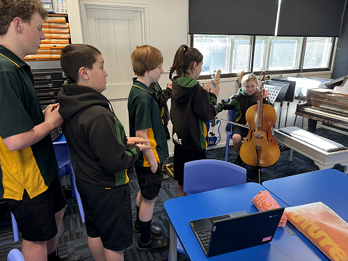 7MK Students playing cello in Year 78 Music class