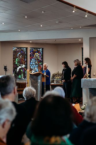 Family reading the prayers of the faithful