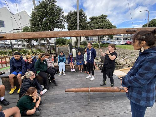 On the Waka Hourua, listening to speaker and interpreter