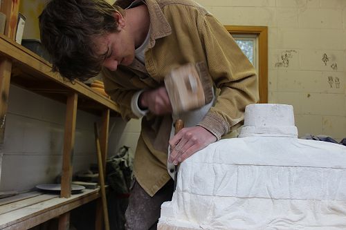 James hard at work with the hammer and chisel