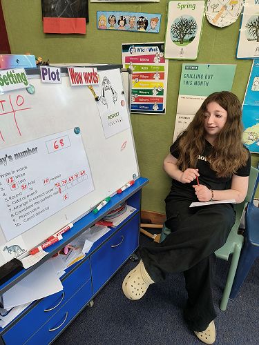 Paige taking the students answers for the maths task