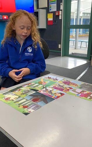 Amelia using pictures to retell a story in sequence