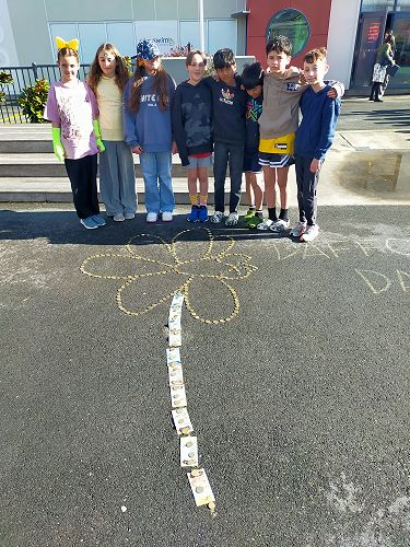 Here is our 2025 house captains with the daffodil filled with gold coin donations.