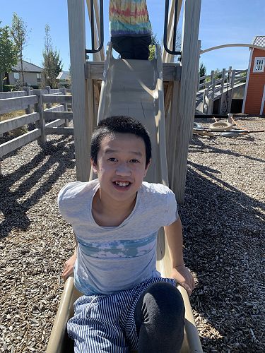 Huge smiles from Timothy on the smaller slide. 