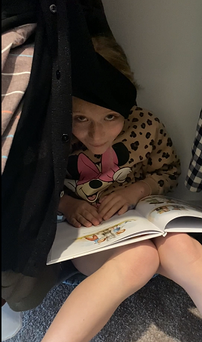 Charlotte Hussey reading in an unusual place