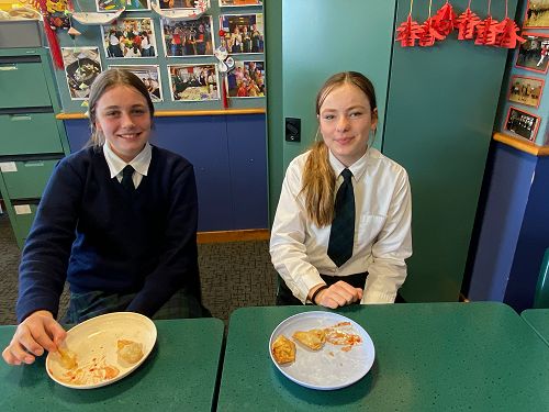 Lily Walker and Livi Arnold eating wontons