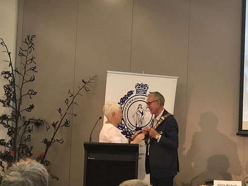 President Terry Byrne being presented with the RFNZJA Chain of Office by Past President Rachel O'Grady