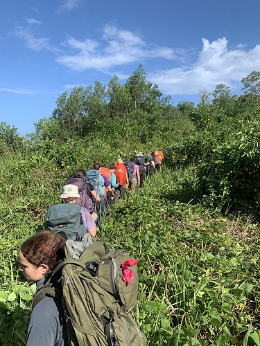 Jungle trekking during a rare clearing