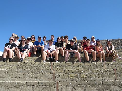 The group sit at the top of the theatre, Pompei.