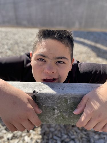 Caleb had a great time exploring. He was peeking through one of the wooden fences. 
