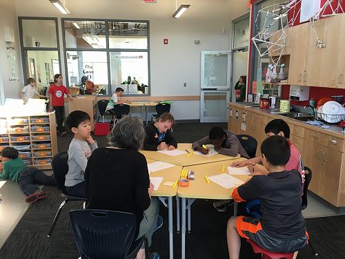 Guided writing group in common area of the Learning community