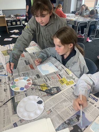 India Allison, Emily North paint their tiles.