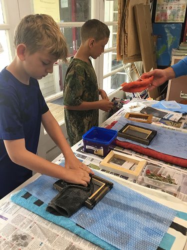 Jake drying his paper, flattening it.