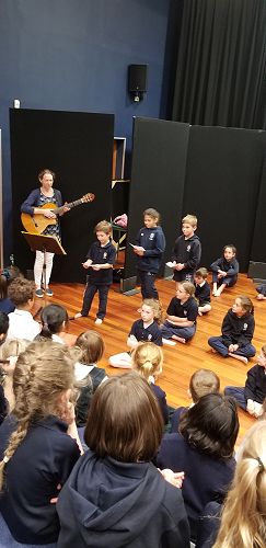 Connor Sinclair explaining one of the waiata to the Junior School