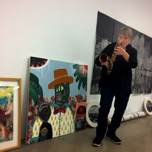 Jane Venis with her artwork "You Saxy Thing" alongside pieces by other artists in the exhibition Anything Could Happen