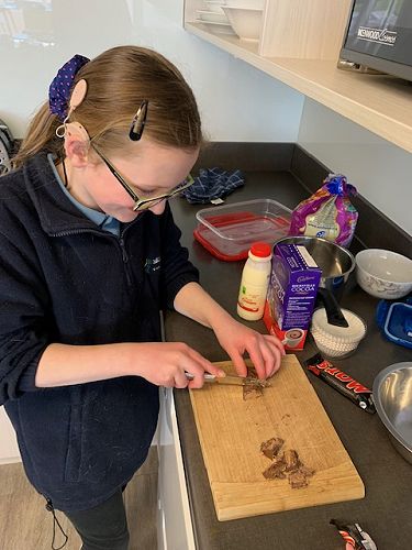 Grace chopping up the mars bar