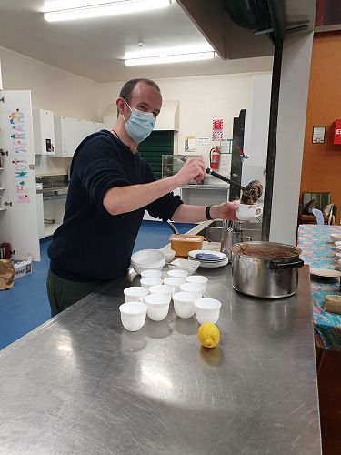 Hugh Laurenson dishes out lentil soup at the Operation Refugee Banquet