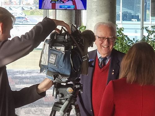 Photo shows Past RI Director John Thorne with reporter and cameraman from Channel 7, at media launch of Basic Education and Literacy Rotary Action Group’s Encyclopaedia project.  (July 2021)