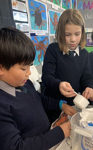 Peter Choi helps Eden Walker with her activity