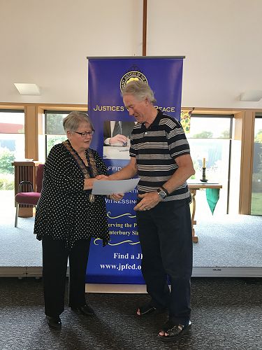 Francis Muntz receiving his Ministry of Justice 40 year Long Service  Certificate from Royal Federation President Denise Hutchins