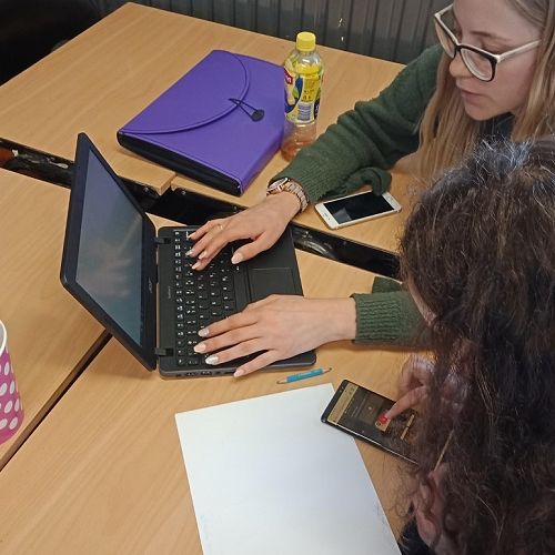 Year 13 Students collaborating on a study guide for their upcoming english exam.