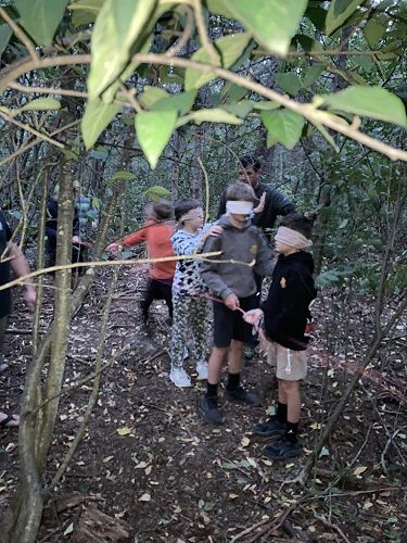 Riwai, Archie and Xion on the nightline- a rope through the forest they have to follow, blindfolded.