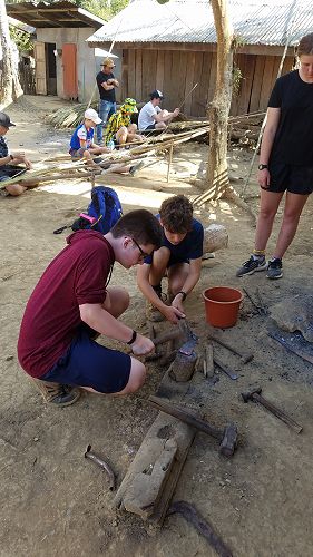 Students try their hand at blacksmithery.