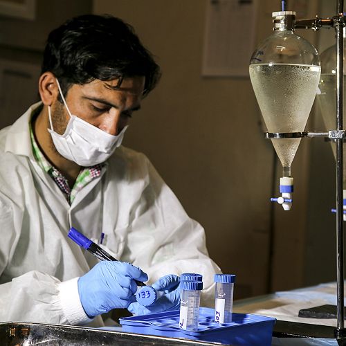 A laboratory worker in Pakistan testing for the presence of polio virus in the sewage in high-risk locations.