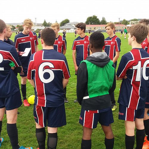 The first XI football team talking tactics by there Coach Mr Adamson at the Recently held Southern Catholic schools tournament.