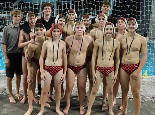 The triumphant Junior Red team with coaches Matthew Lander and Geordie Chapman.