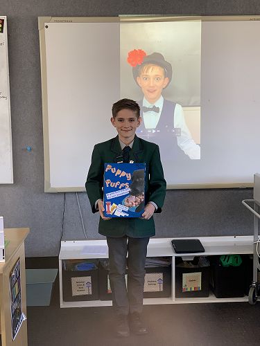 Samuel with his finished product and advertisement