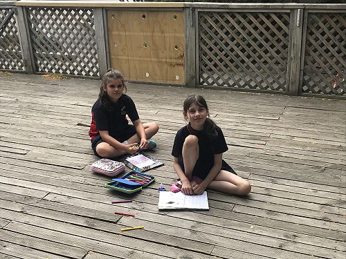 Awhina and Faith working hard and enjoying the sun on the deck.
