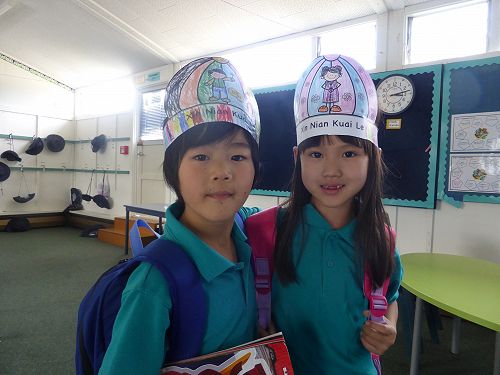 Lewis and Venus Room 22 wearing their Chinese New Year hats.