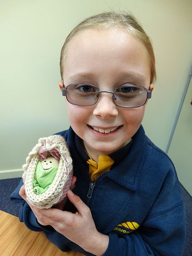 Nakita with her egg warmly wrapped up