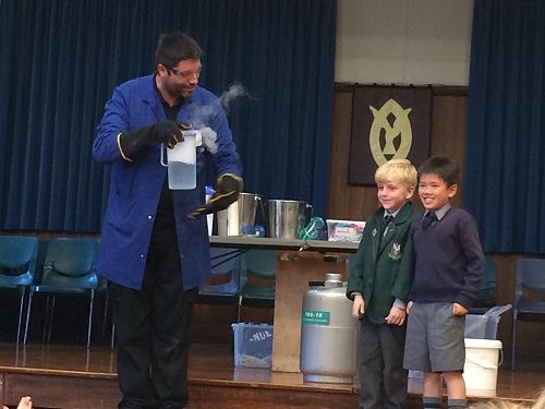 Leo and Ethan looking at liquid nitrogen and water mixed together.