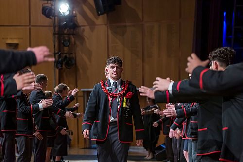 Head boy Christian Ioane leads staff on stage, while being welcomed by the kapa haka group.