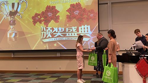 Kayla receiving her prize